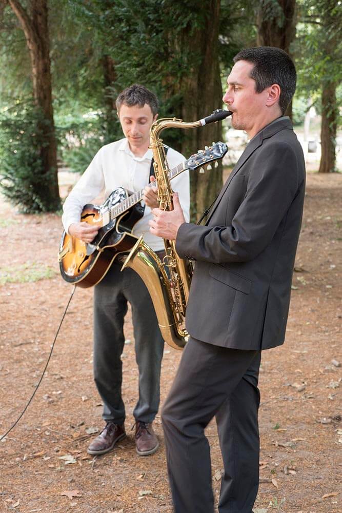 Jazz duo with guitar and saxophone performing at a wedding reception