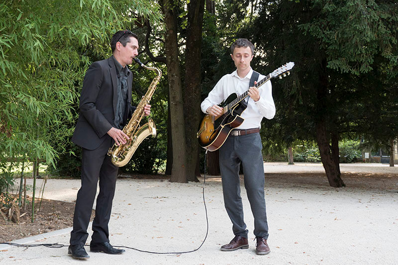 Jazz duo performing live at an outdoor reception in a private park