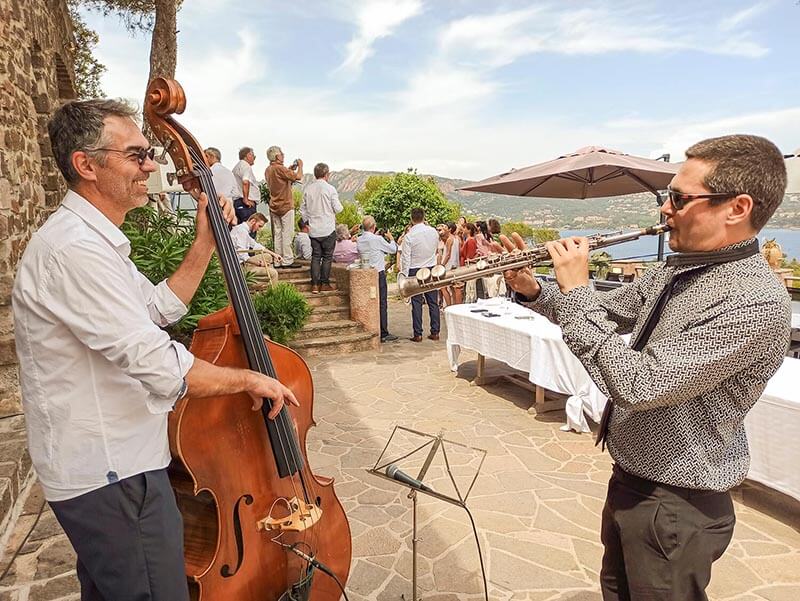 Saxophone and double bass duo performing on an outdoor terrace during a wedding reception