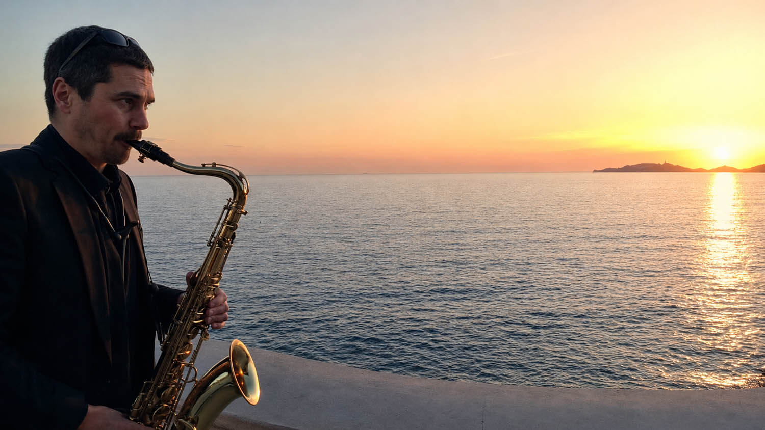 Jazz saxophonist performing at sunset by the Mediterranean on the French Riviera