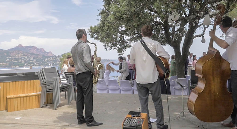 Jazz trio with saxophone, guitar and double bass performing at a seaside wedding ceremony on the French Riviera
